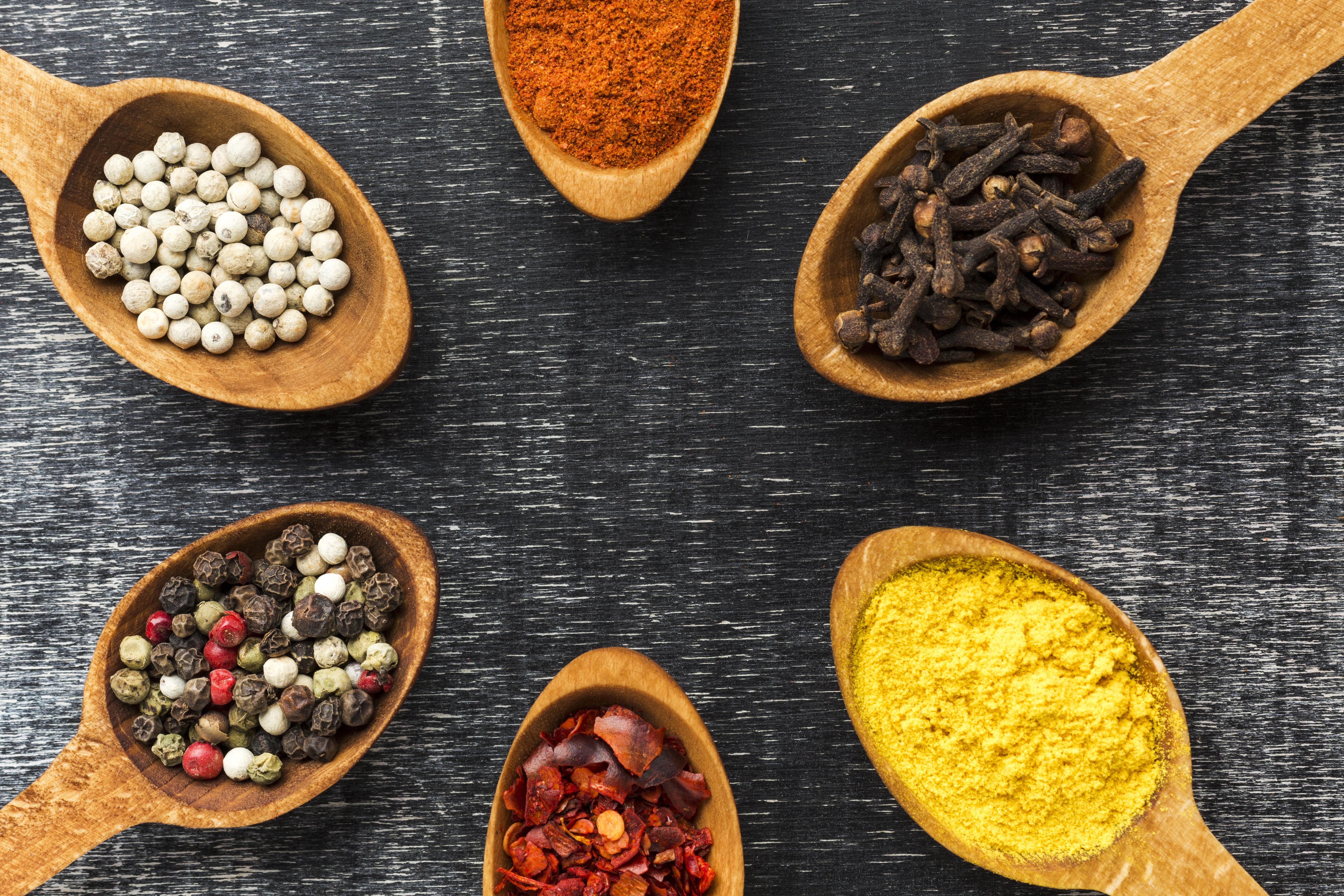 Diverse collection of whole and ground spices from around the world